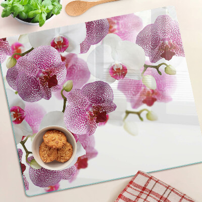 Glass chopping board Orchids in front of the window