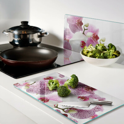 Glass chopping board Orchids in front of the window