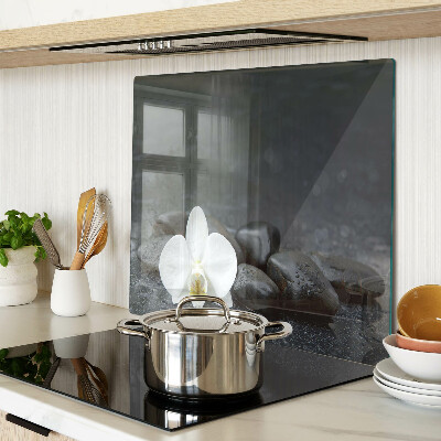 Glass kitchen board Orchid flower on stones