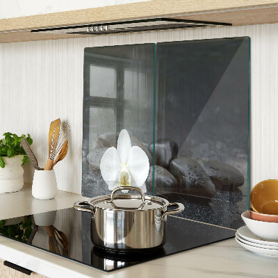 Glass kitchen board Orchid flower on stones