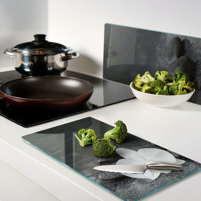Glass kitchen board Orchid flower on stones