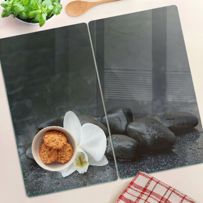 Glass kitchen board Orchid flower on stones