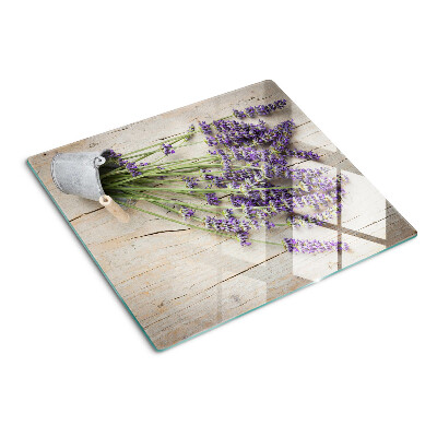 Glass chopping board Lavender in a pot on a wooden background