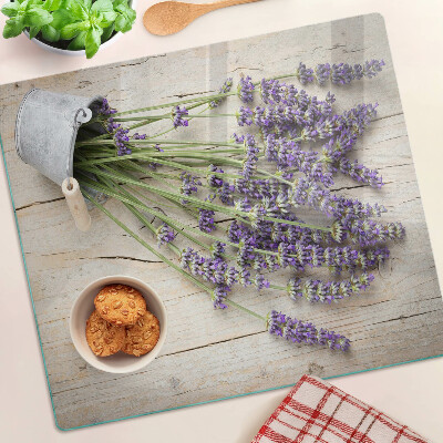 Glass chopping board Lavender in a pot on a wooden background