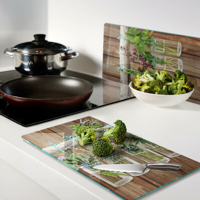 Glass kitchen board Herbs in jars on a wooden background