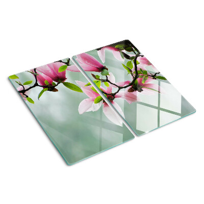 Glass kitchen board Magnolia flowers against a background of greenery