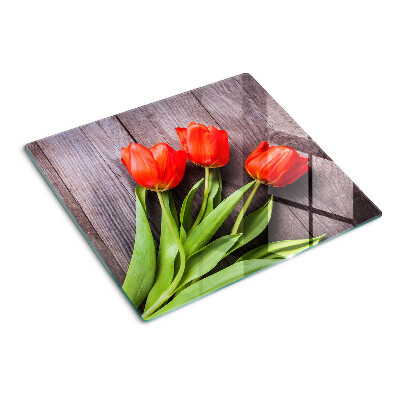 Glass chopping board Tulips on a wooden background