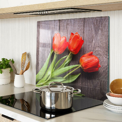 Glass chopping board Tulips on a wooden background