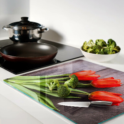 Glass chopping board Tulips on a wooden background