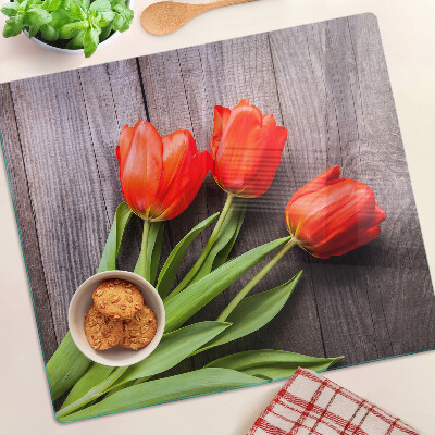 Glass chopping board Tulips on a wooden background