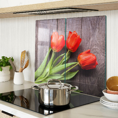 Glass chopping board Tulips on a wooden background