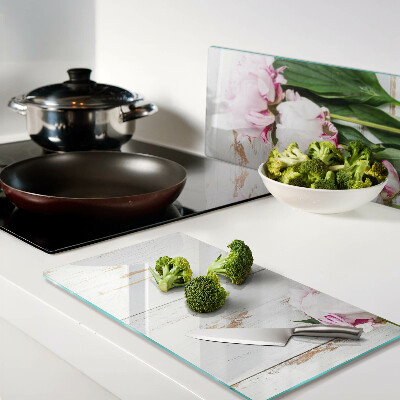 Glass kitchen board Peony flowers on a wood background