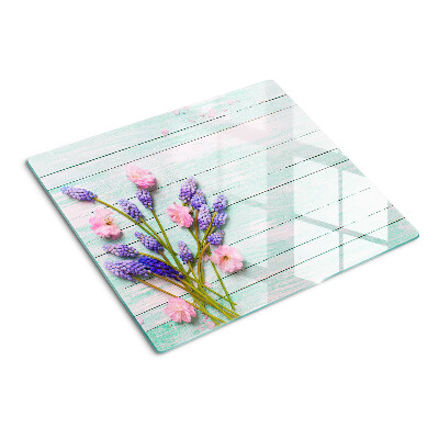 Glass chopping board Flowers on a wooden background
