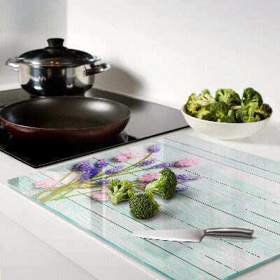 Glass chopping board Flowers on a wooden background