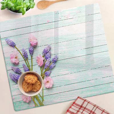 Glass chopping board Flowers on a wooden background