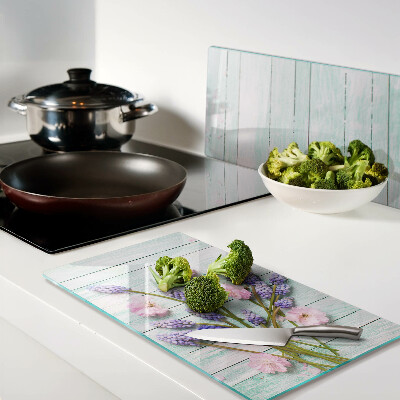 Glass chopping board Flowers on a wooden background
