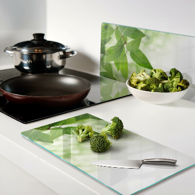Glass chopping board Leaves against a background of blurred green