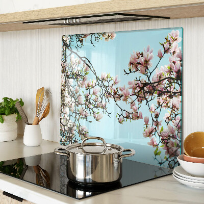 Glass kitchen board Magnolia flowers on a blue background