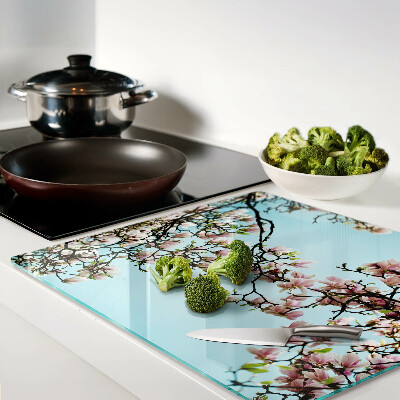 Glass kitchen board Magnolia flowers on a blue background