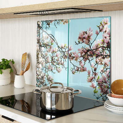 Glass kitchen board Magnolia flowers on a blue background