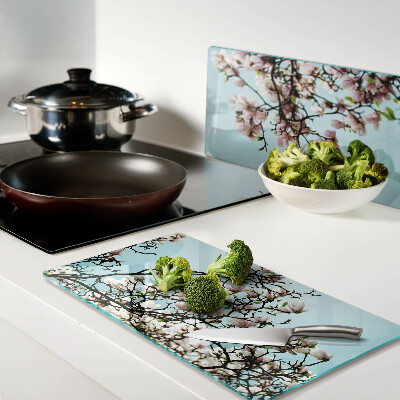Glass kitchen board Magnolia flowers on a blue background