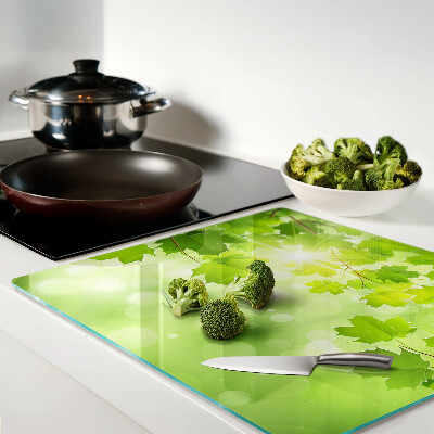 Glass kitchen board Leaves in the sun's rays