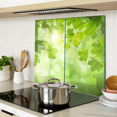 Glass kitchen board Leaves in the sun's rays