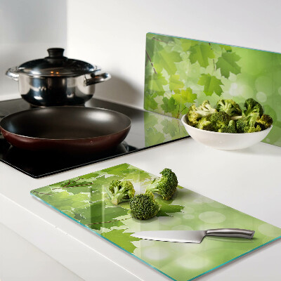 Glass kitchen board Leaves in the sun's rays
