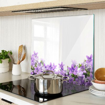 Glass kitchen board Purple flowers in the background