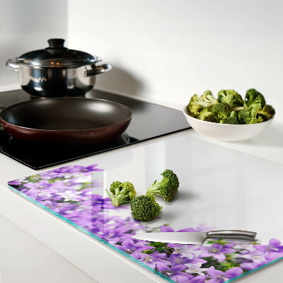 Glass kitchen board Purple flowers in the background