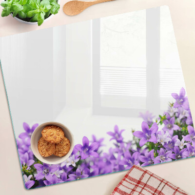 Glass kitchen board Purple flowers in the background
