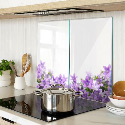 Glass kitchen board Purple flowers in the background