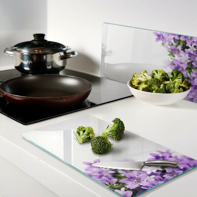 Glass kitchen board Purple flowers in the background