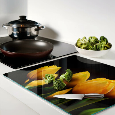 Glass kitchen board Yellow tulips on a black background