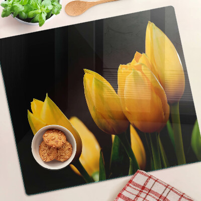 Glass kitchen board Yellow tulips on a black background