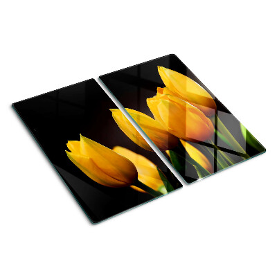 Glass kitchen board Yellow tulips on a black background