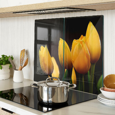 Glass kitchen board Yellow tulips on a black background