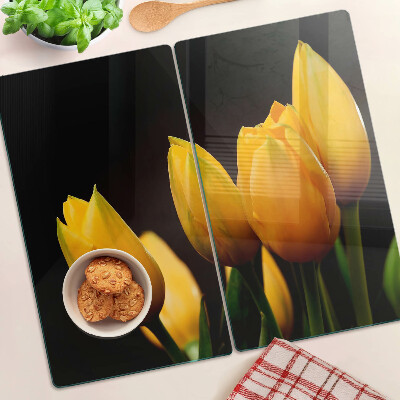 Glass kitchen board Yellow tulips on a black background