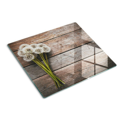 Glass kitchen board Dandelion flowers on a wooden background