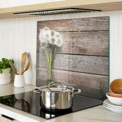 Glass kitchen board Dandelion flowers on a wooden background