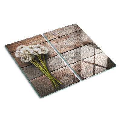 Glass kitchen board Dandelion flowers on a wooden background