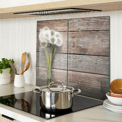 Glass kitchen board Dandelion flowers on a wooden background