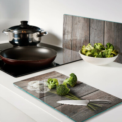 Glass kitchen board Dandelion flowers on a wooden background