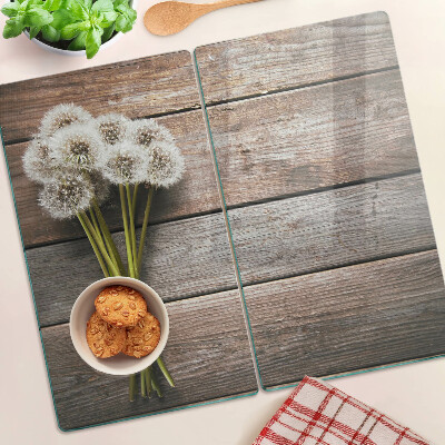 Glass kitchen board Dandelion flowers on a wooden background
