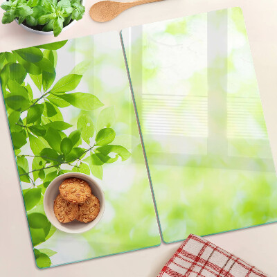 Glass chopping board Green leaves in the light