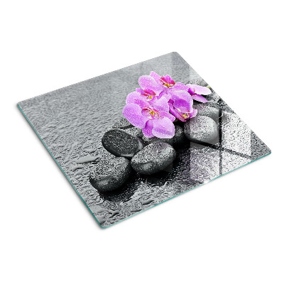 Glass chopping board Flowers and stones against the water