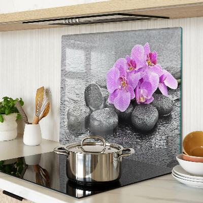 Glass chopping board Flowers and stones against the water