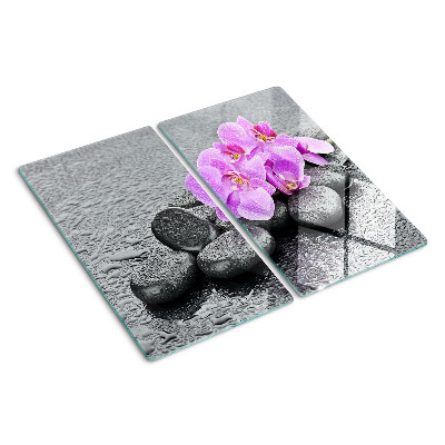 Glass chopping board Flowers and stones against the water