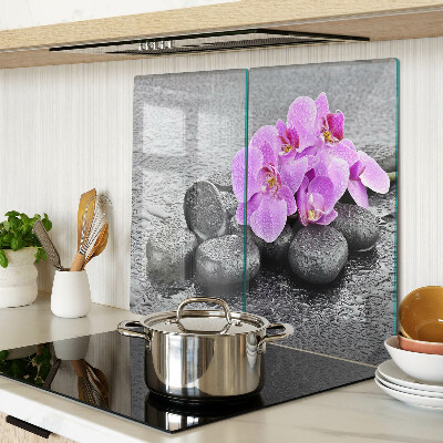 Glass chopping board Flowers and stones against the water