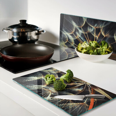 Glass chopping board Dandelions in macro photography